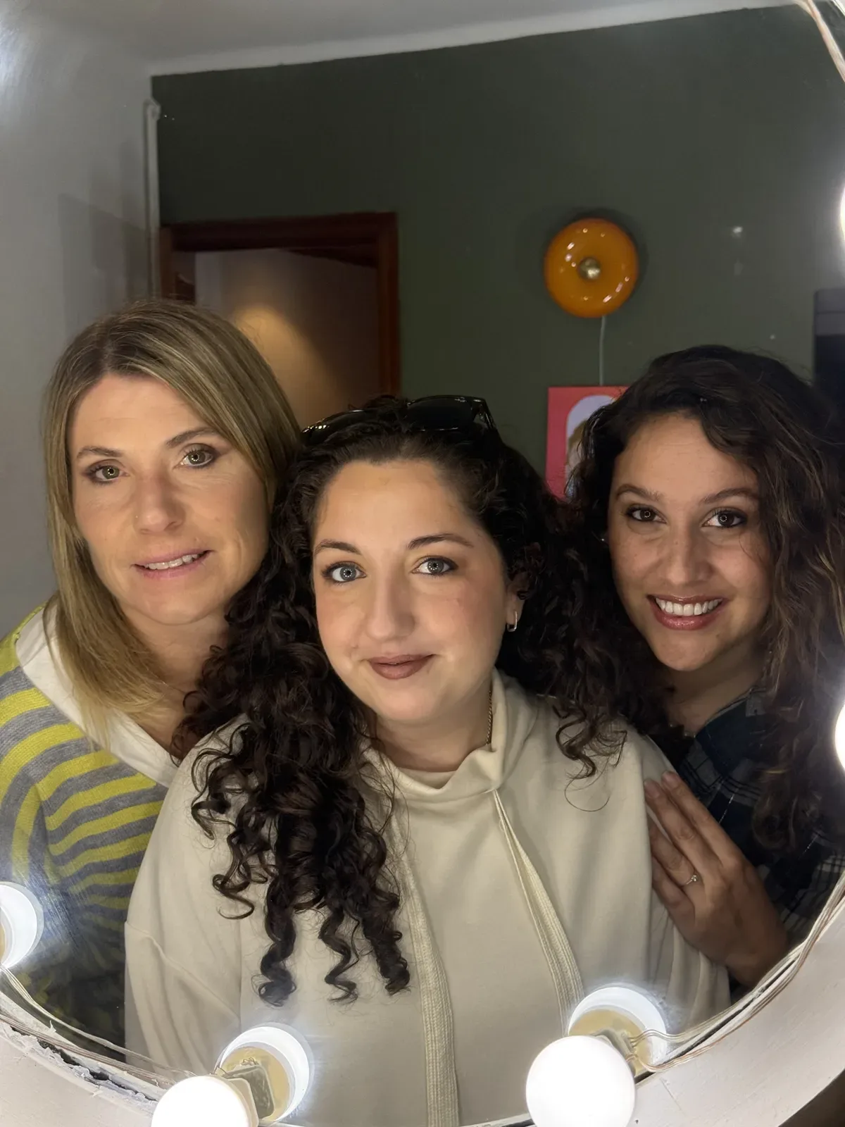 Tres amigas frente al espejo tras su clase grupal de automaquillaje en Barcelona